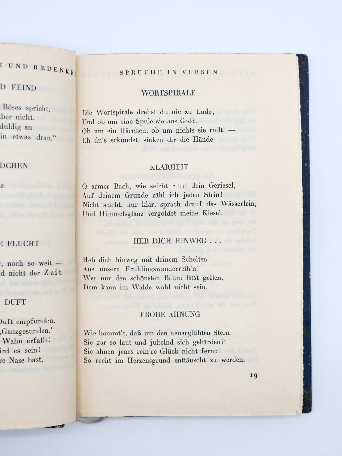Open book with German text on a white background