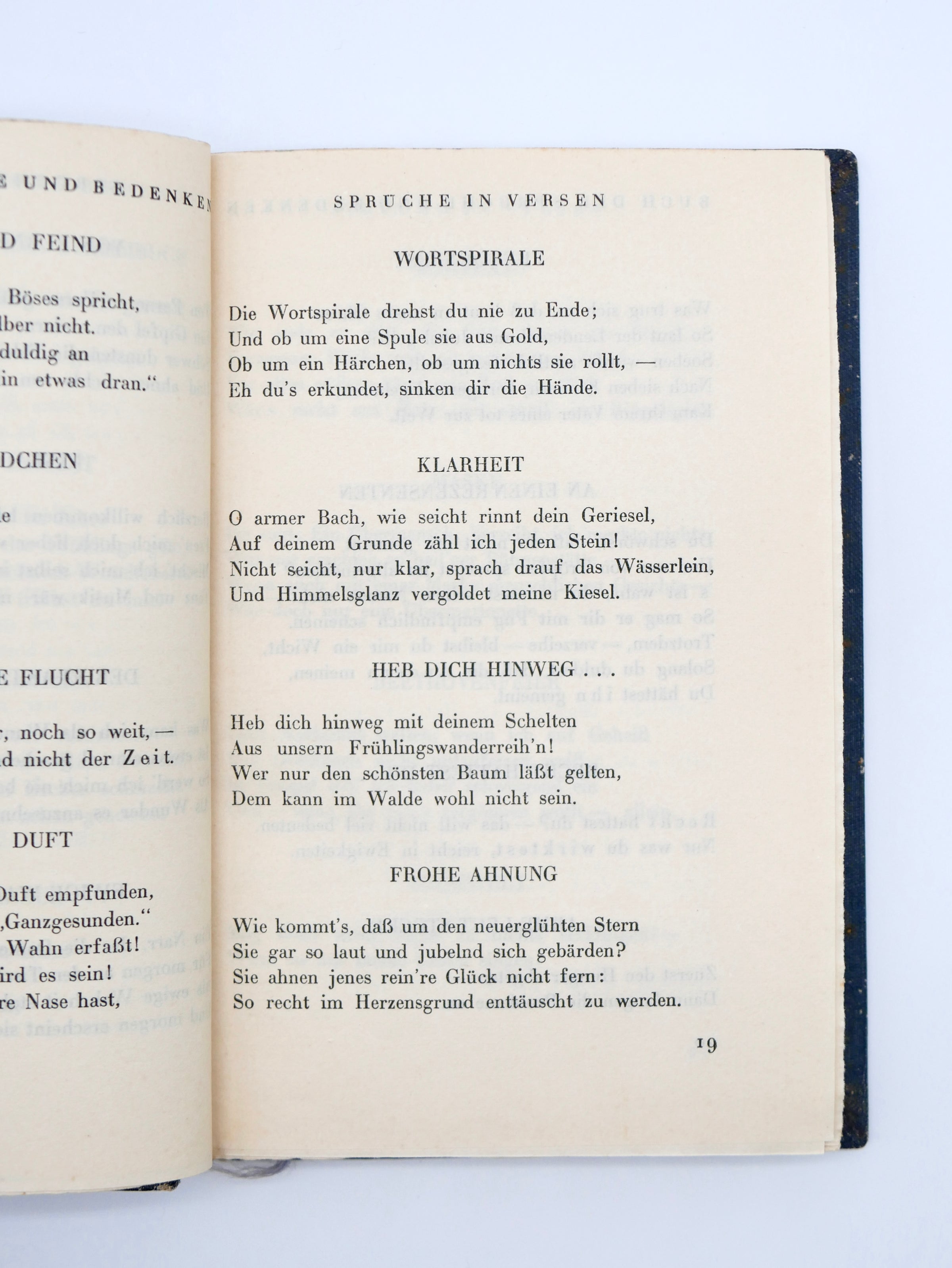 Open book with German text on a white background