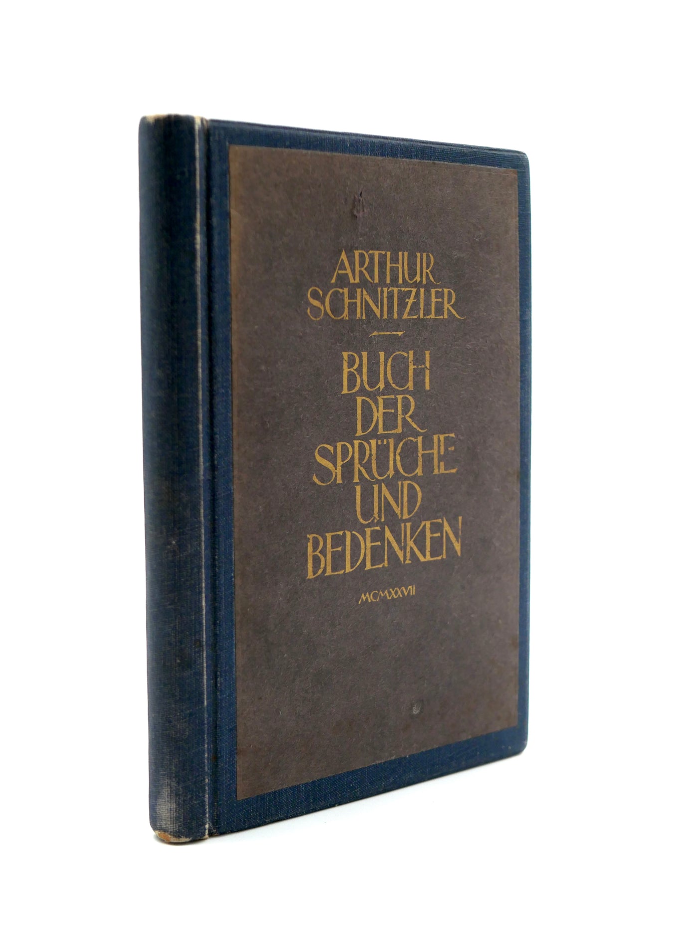 Vintage book with brown and blue cover and gold text on a white background
