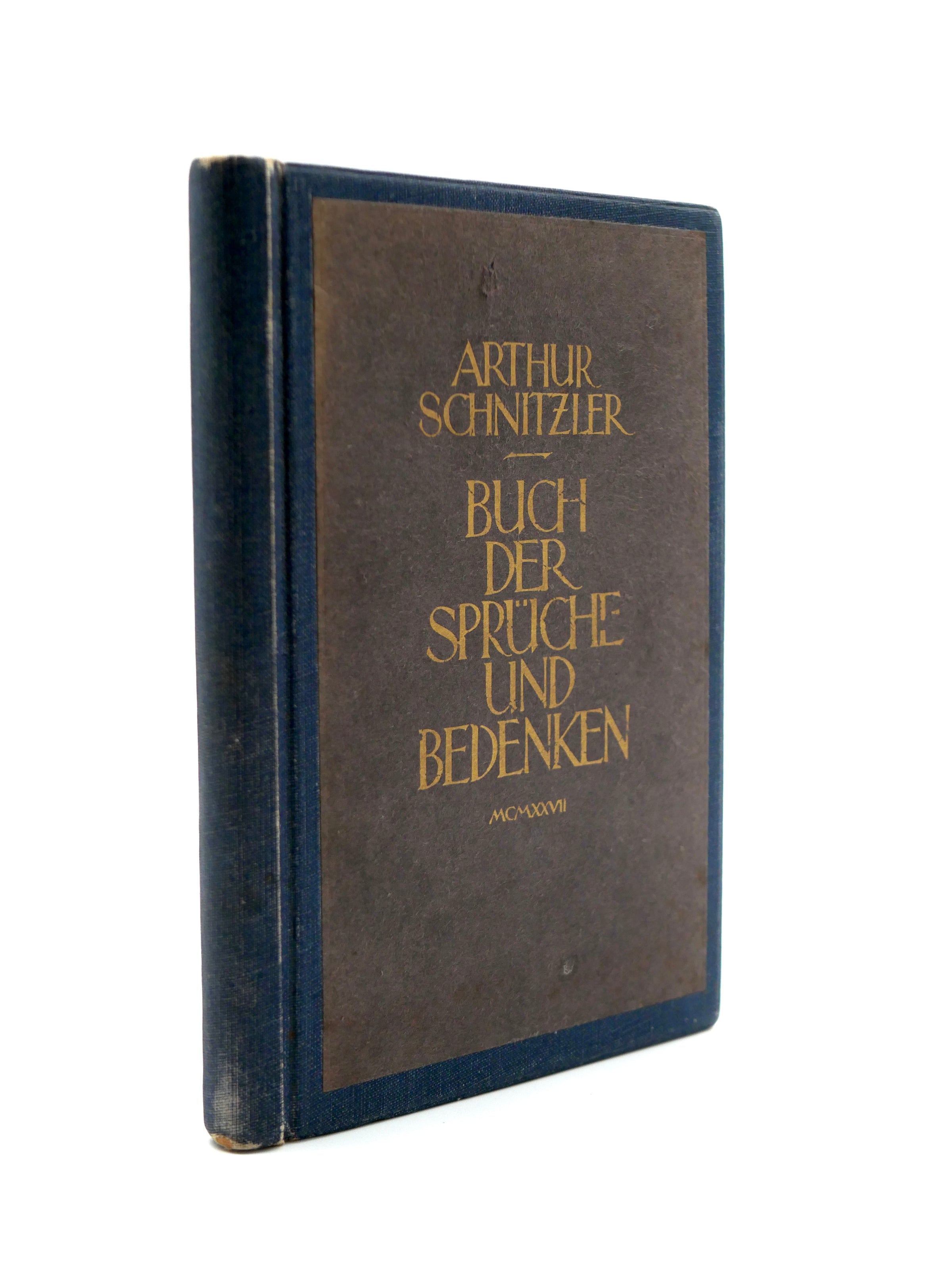 Vintage book with brown and blue cover and gold text on a white background