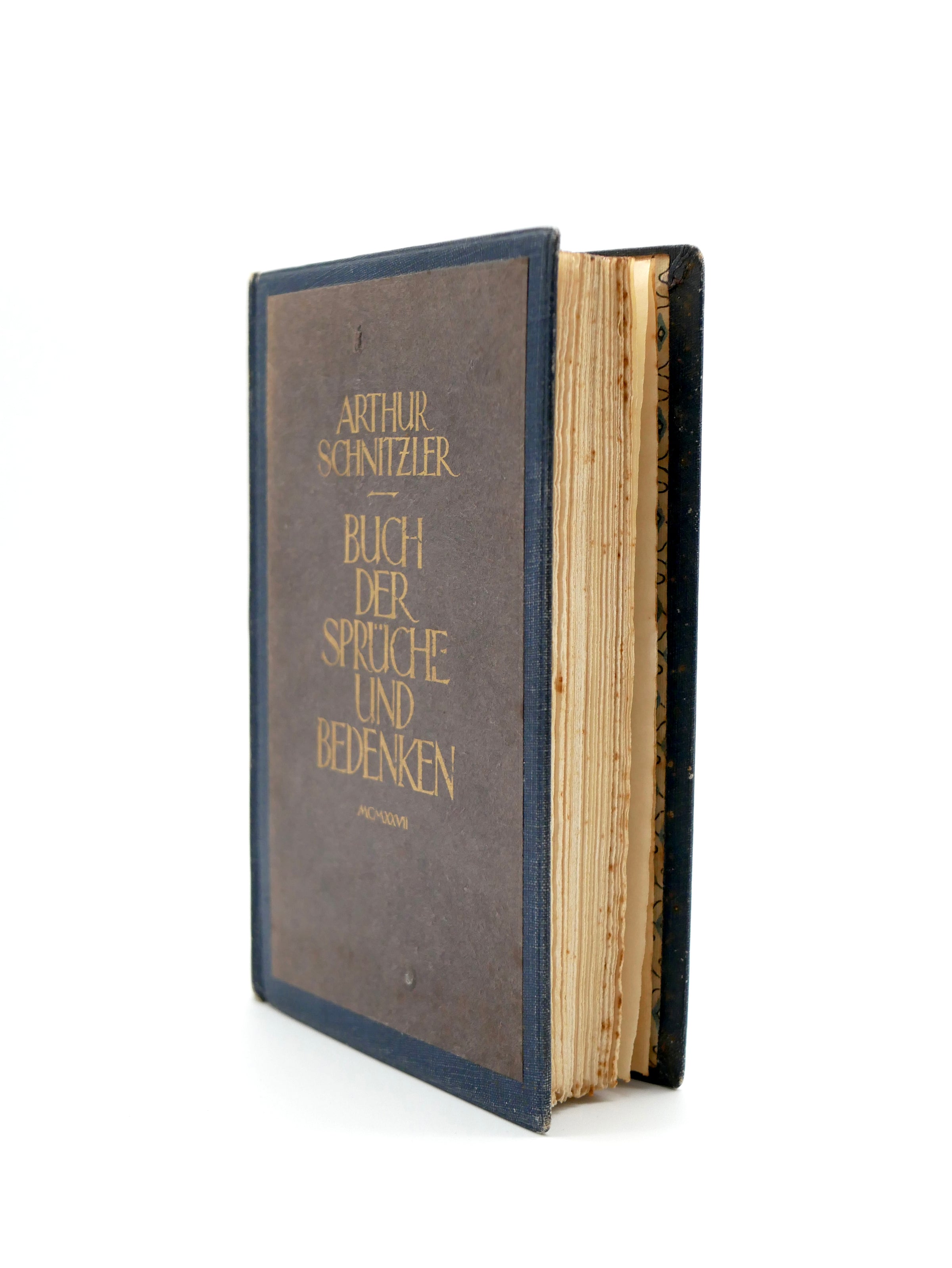 Vintage book with leather binding and gold text on a white background