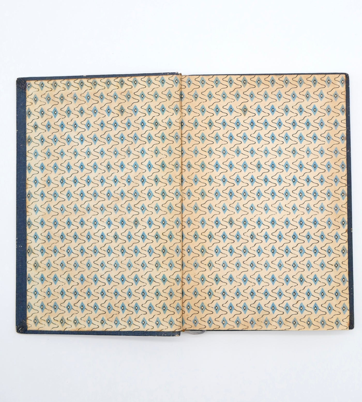 Open book with floral pattern on beige pages against a white background