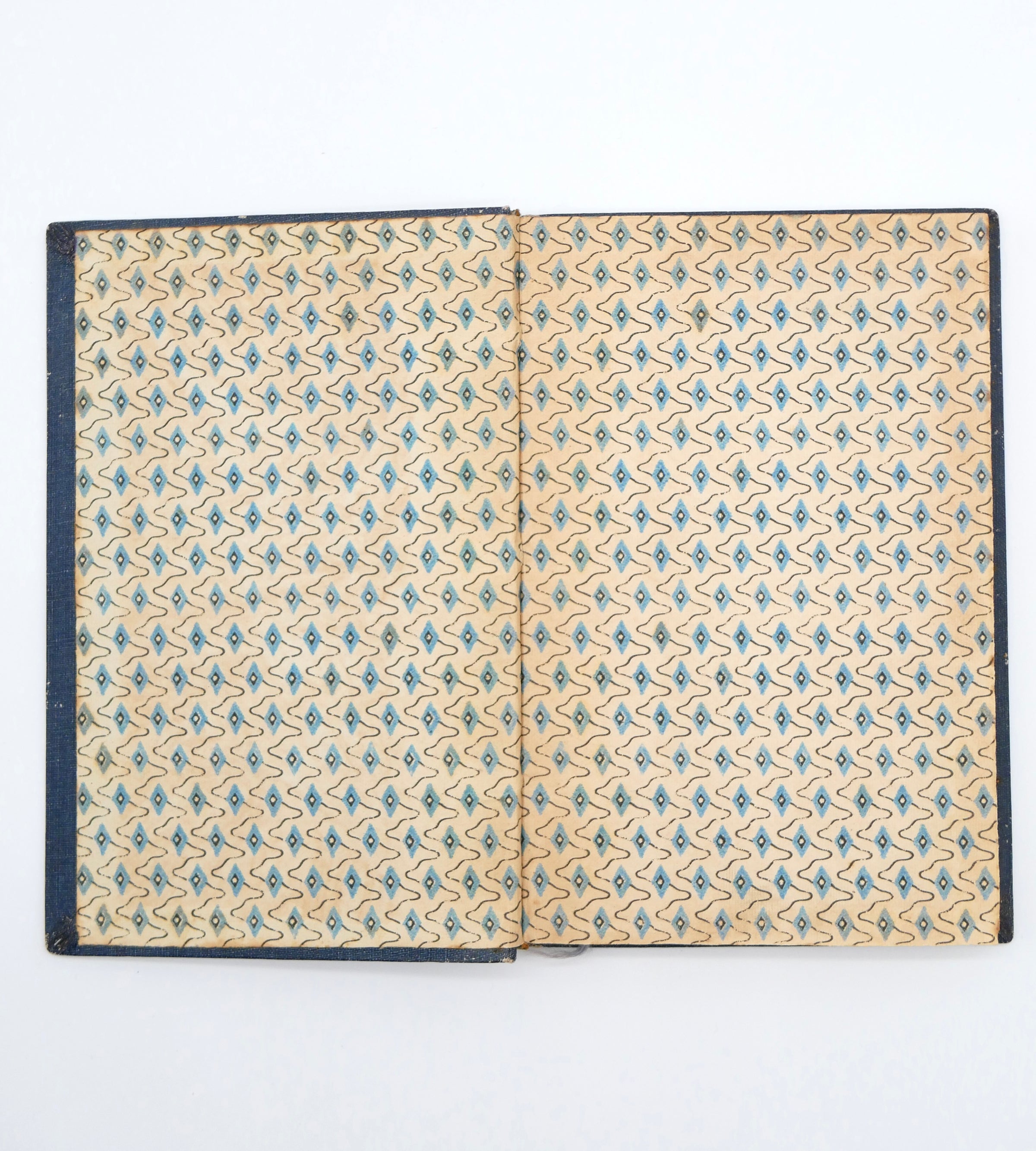 Open book with floral pattern on beige pages against a white background