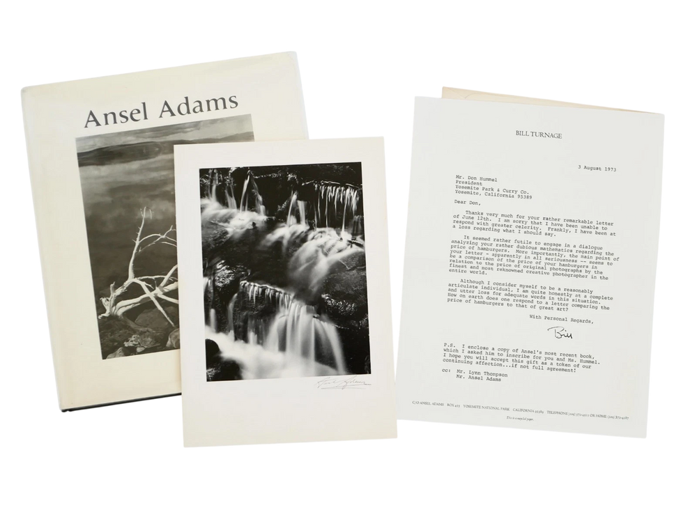 Ansel Adams book with black and white photographs of nature on a white background