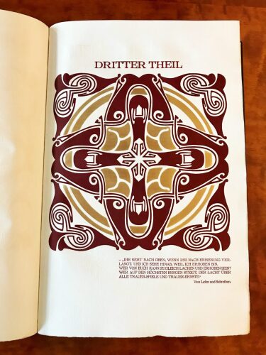 Third part-title in burgundy and gold
