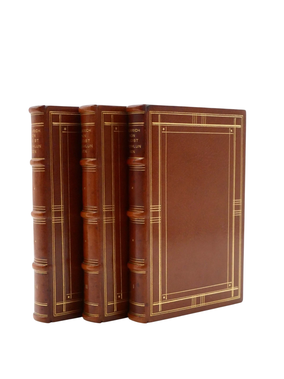 Three leather-bound books stacked on a white background