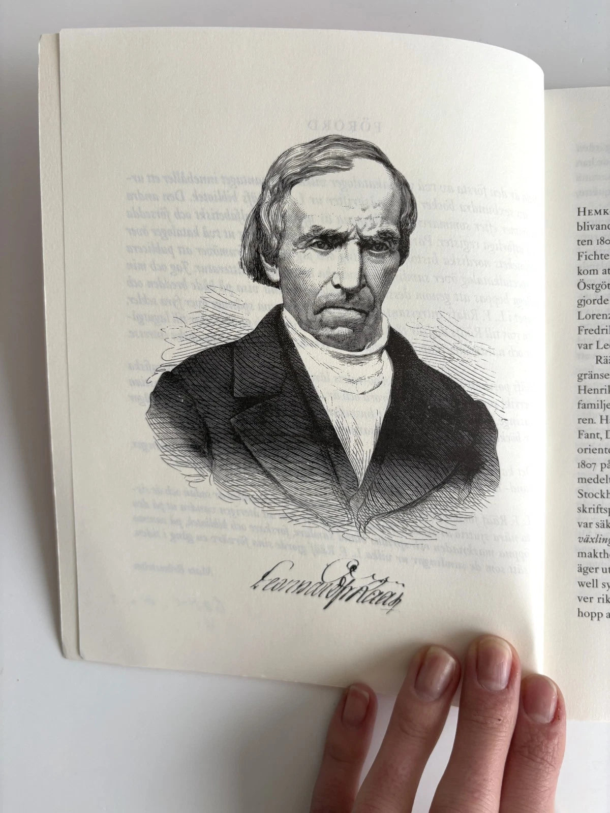 Open book with a black and white portrait of a man on a white background