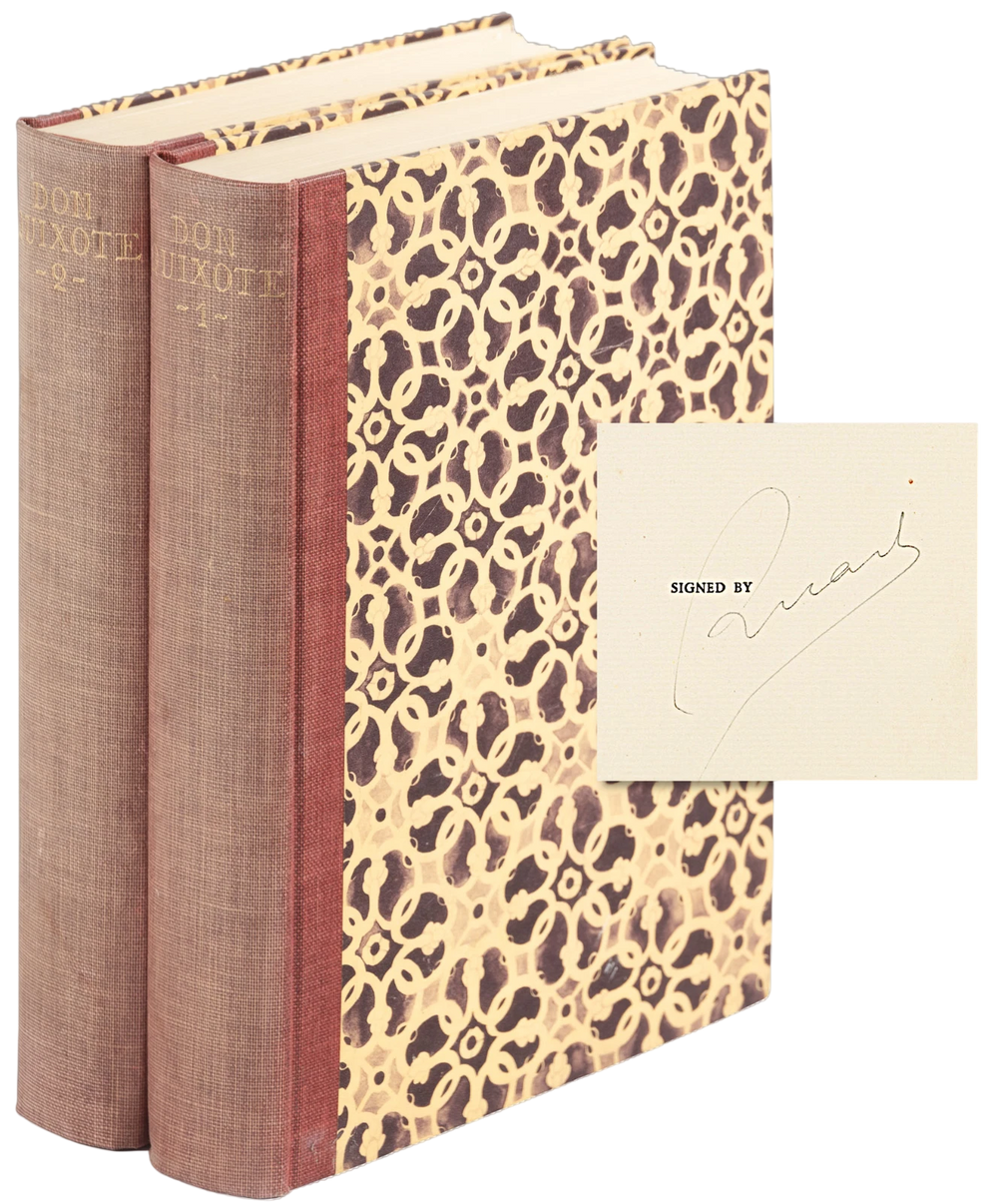 Two books with patterned spines and a signed card on a white background